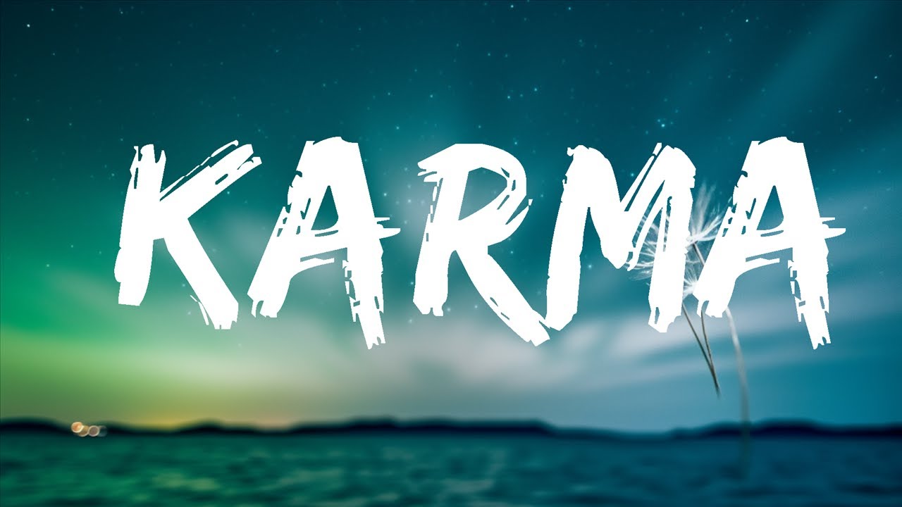 The word Karma over mountains at night